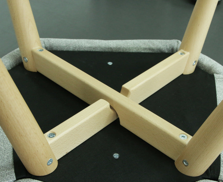 Wooden frame of Alba chair with metal screws on a gray background - bottom view