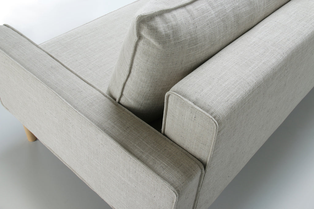 Top back view of white Alpine sofa bed with upholstered armrest on a white background.