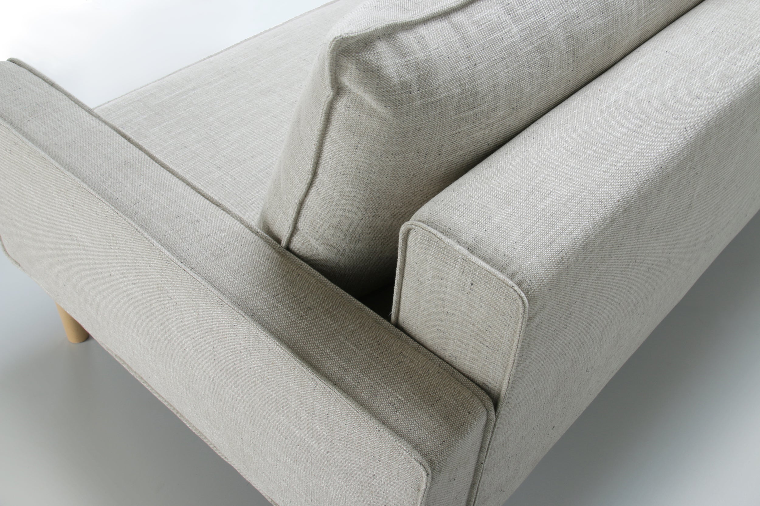 Top back view of white Alpine sofa bed with upholstered armrest on a white background.