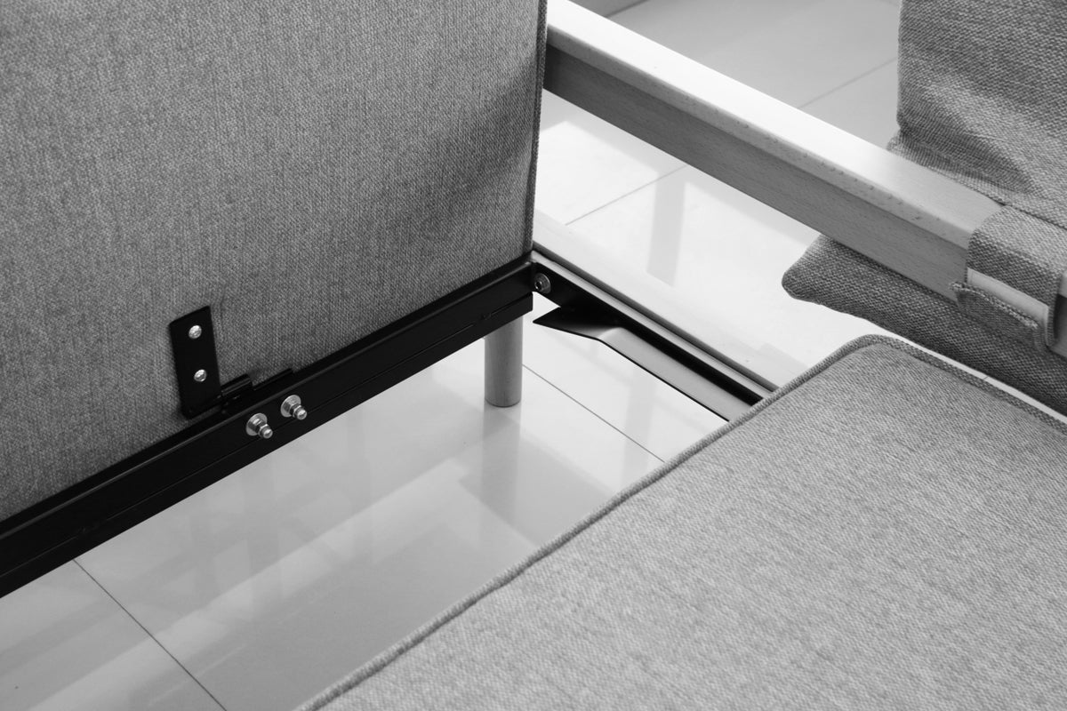 Detail view of white extended Alpine sofa bed with upholstered armrest on a white background.
