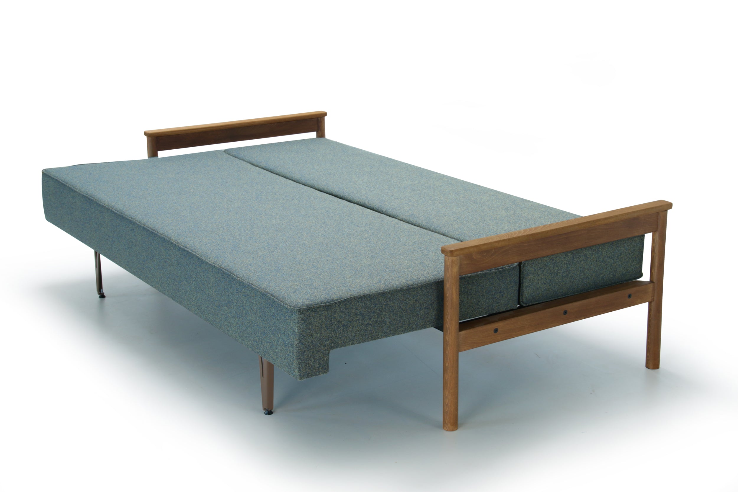 Green Alpine extended sofa bed with wooden armrest on a white background.