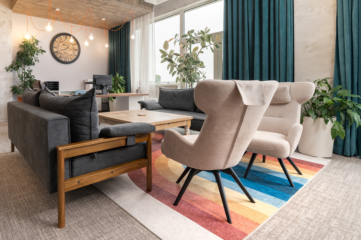 Modern living room with Alpine sofa bed, beige Dreamline chairs, and colorful rug.