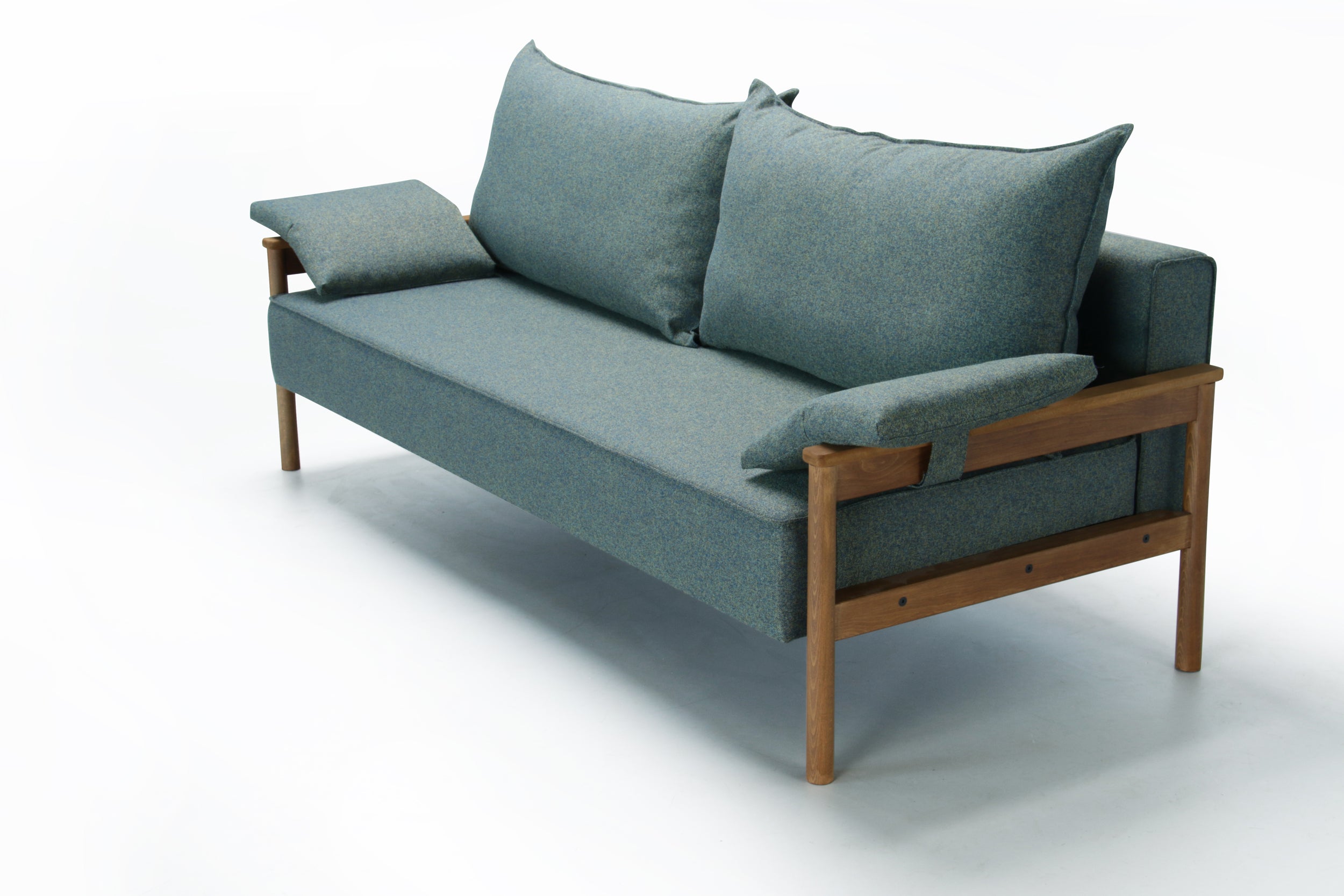 Green Alpine sofa bed with wooden armrest on a white background.