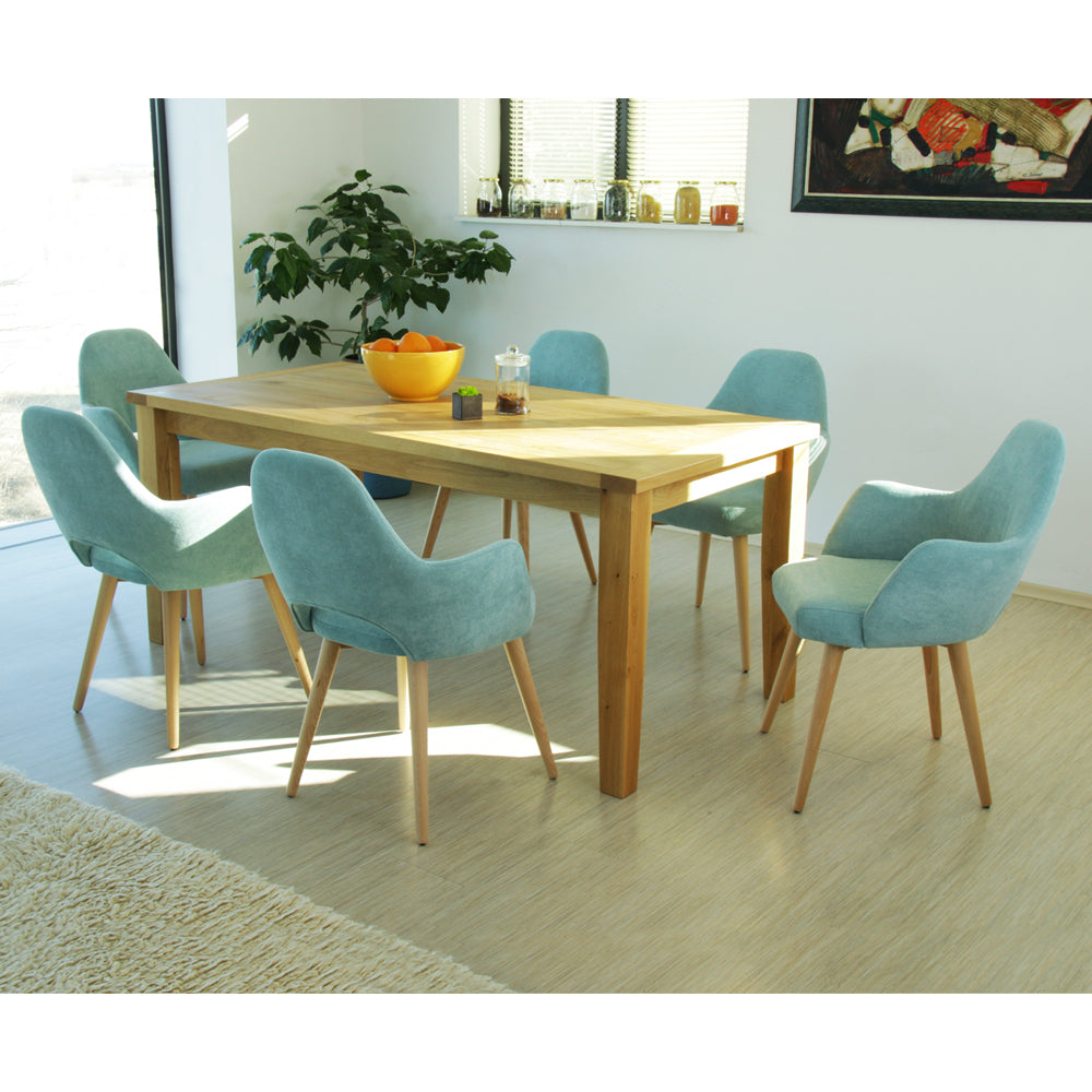 Dining room with wooden table and light blue Andre chairs.