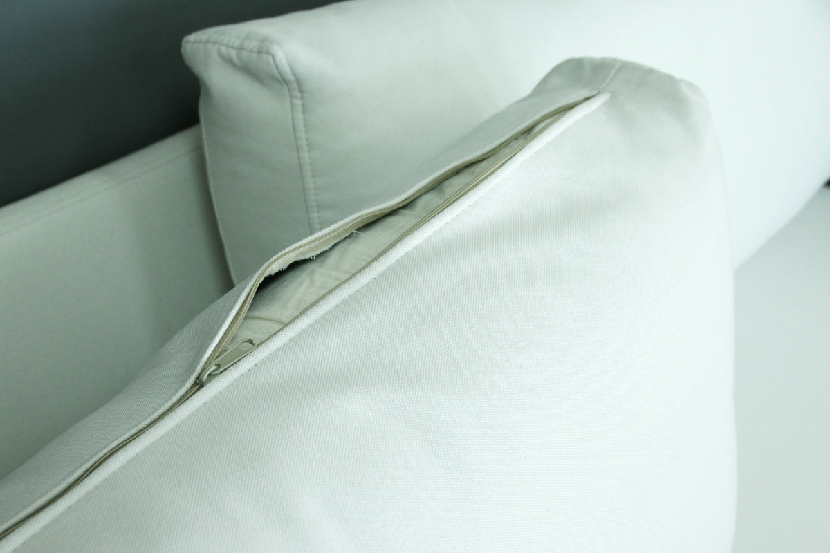 Close-up of a light gray B12 sofa with a removable upholstery - zipper detail