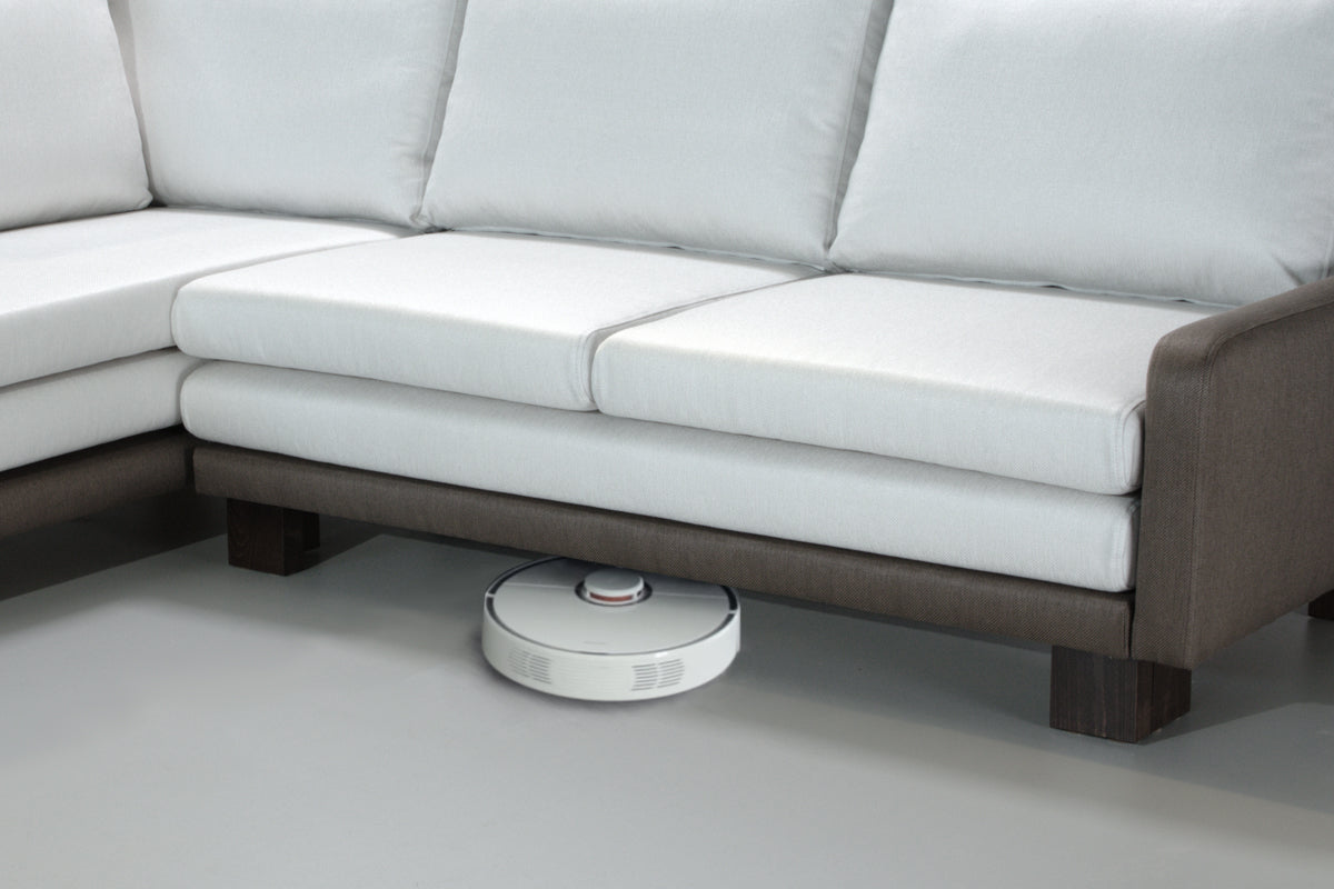 Robotic vacuum cleaner cleaning under a B12 sofa bed.