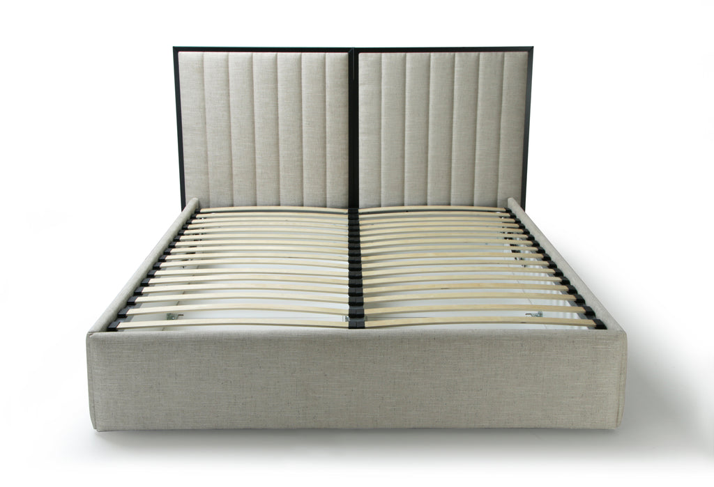 An upholstered bed frame with a tall segmented headboard and slatted base, shown on a clean white background.