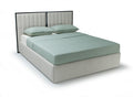 A modern platform bed with a light beige upholstered base and headboard, featuring a mint green mattress and matching pillows, shown on a white background.