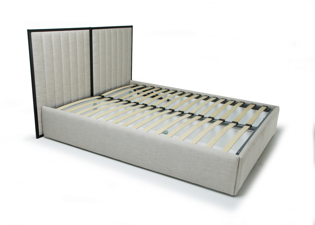 An upholstered platform bed frame with a tall, vertically channel-tufted headboard and slatted base, shown on a clean white background.