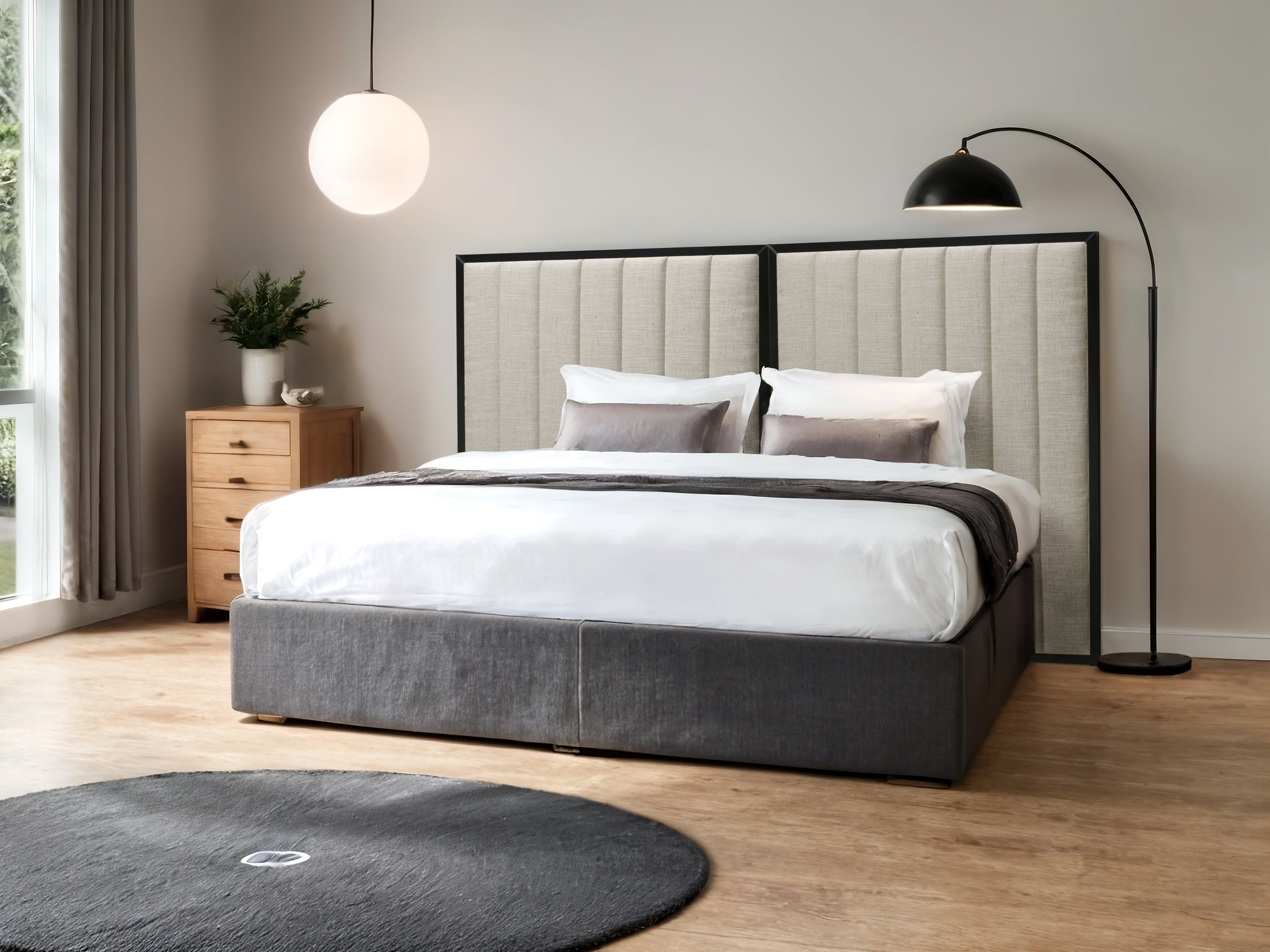 Modern bedroom with a bed, headboard with a stitched beige upholstery and black frame, nightstands, and decorative elements.