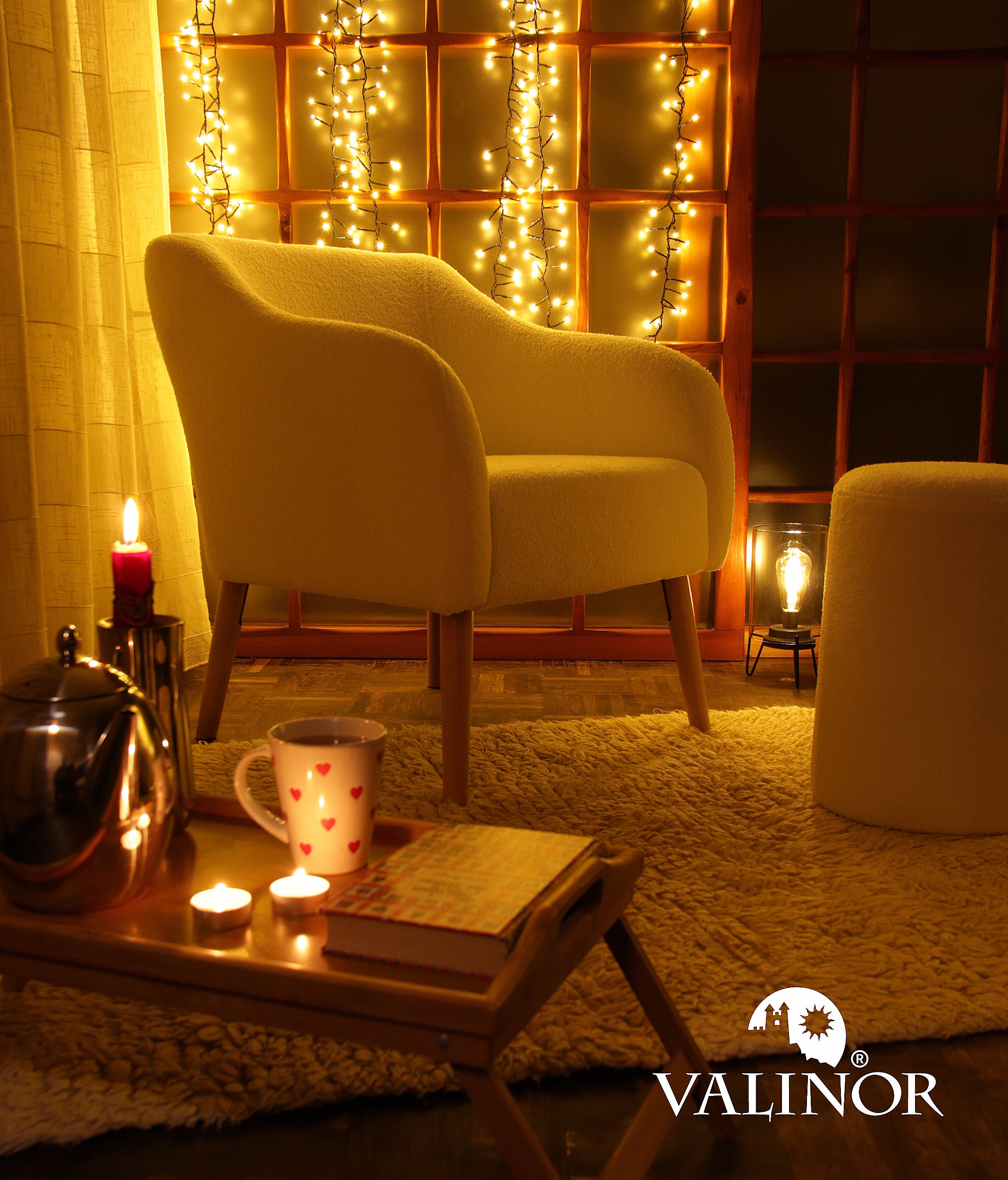 Cozy NEW YEAR  living room with a Juno armchair, table, and candles, featuring the Valinor brand.