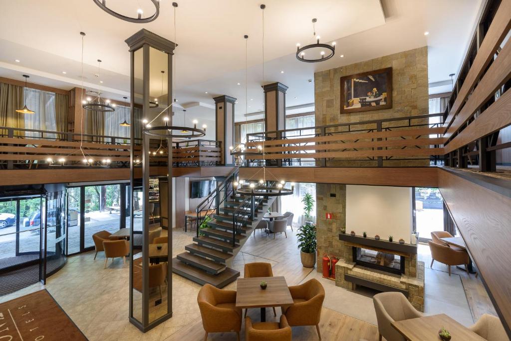 Modern hotel lobby with staircase, tables, and Juno armchairs.