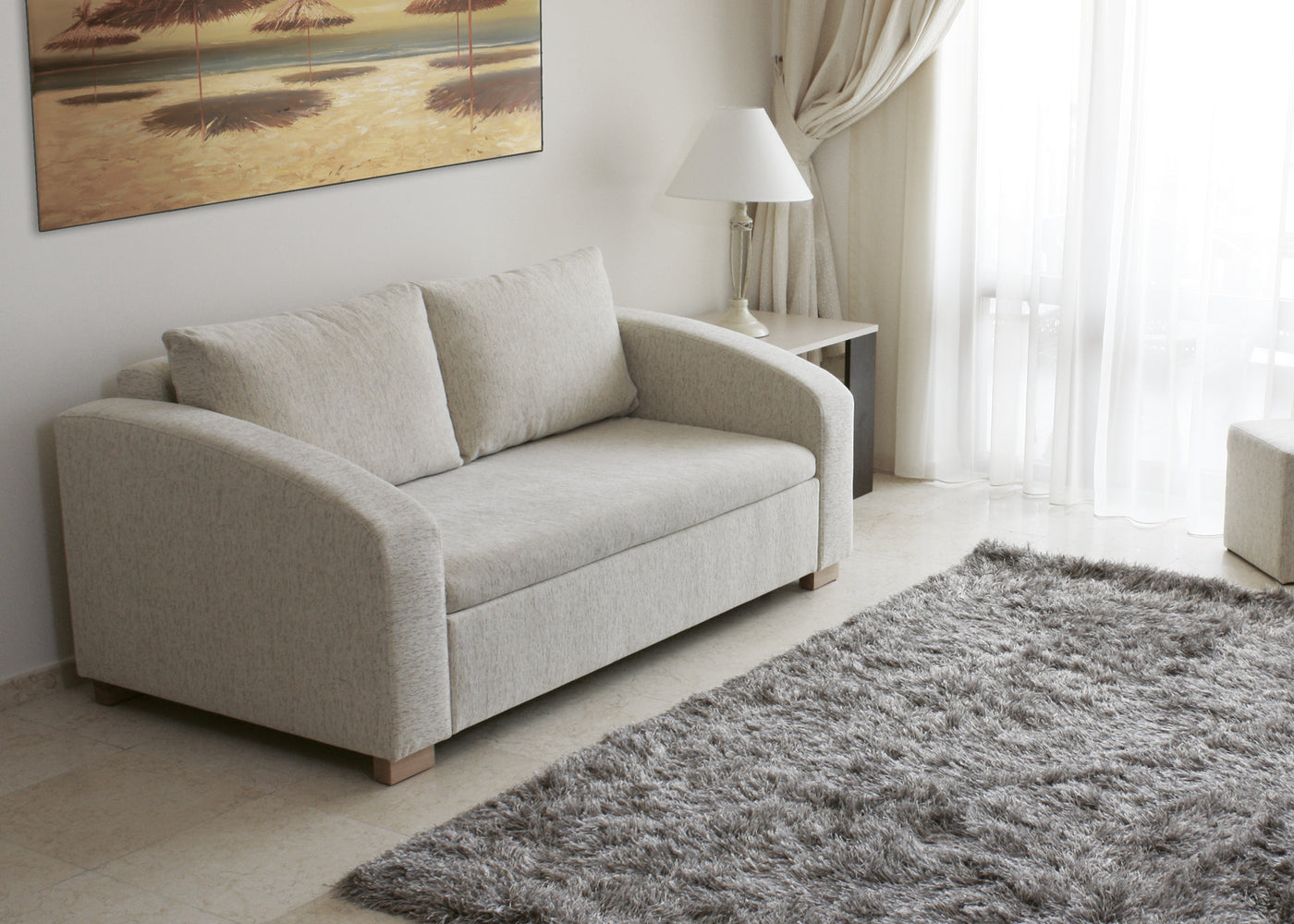 Gray sofa MAX in a living room with a rug and wall art