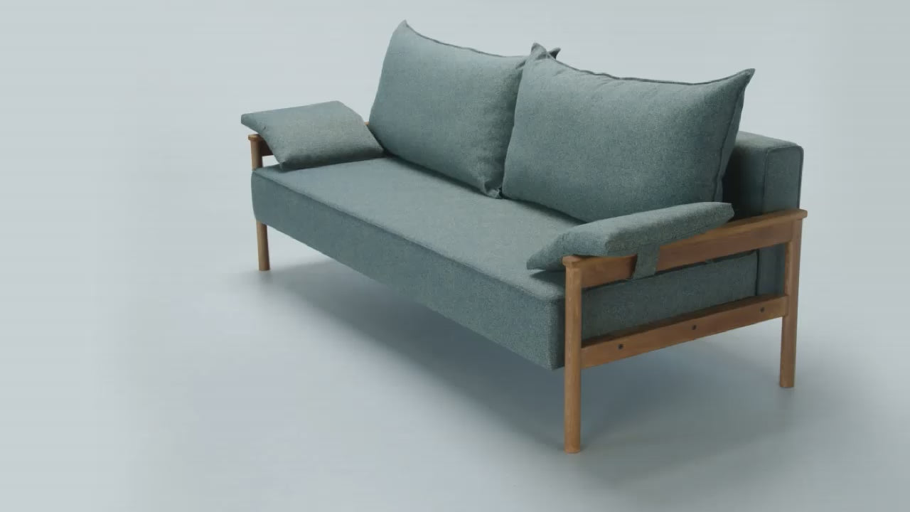 Video of extension of Alpine sofa bed mechanism with wooden armrest on a white background.
