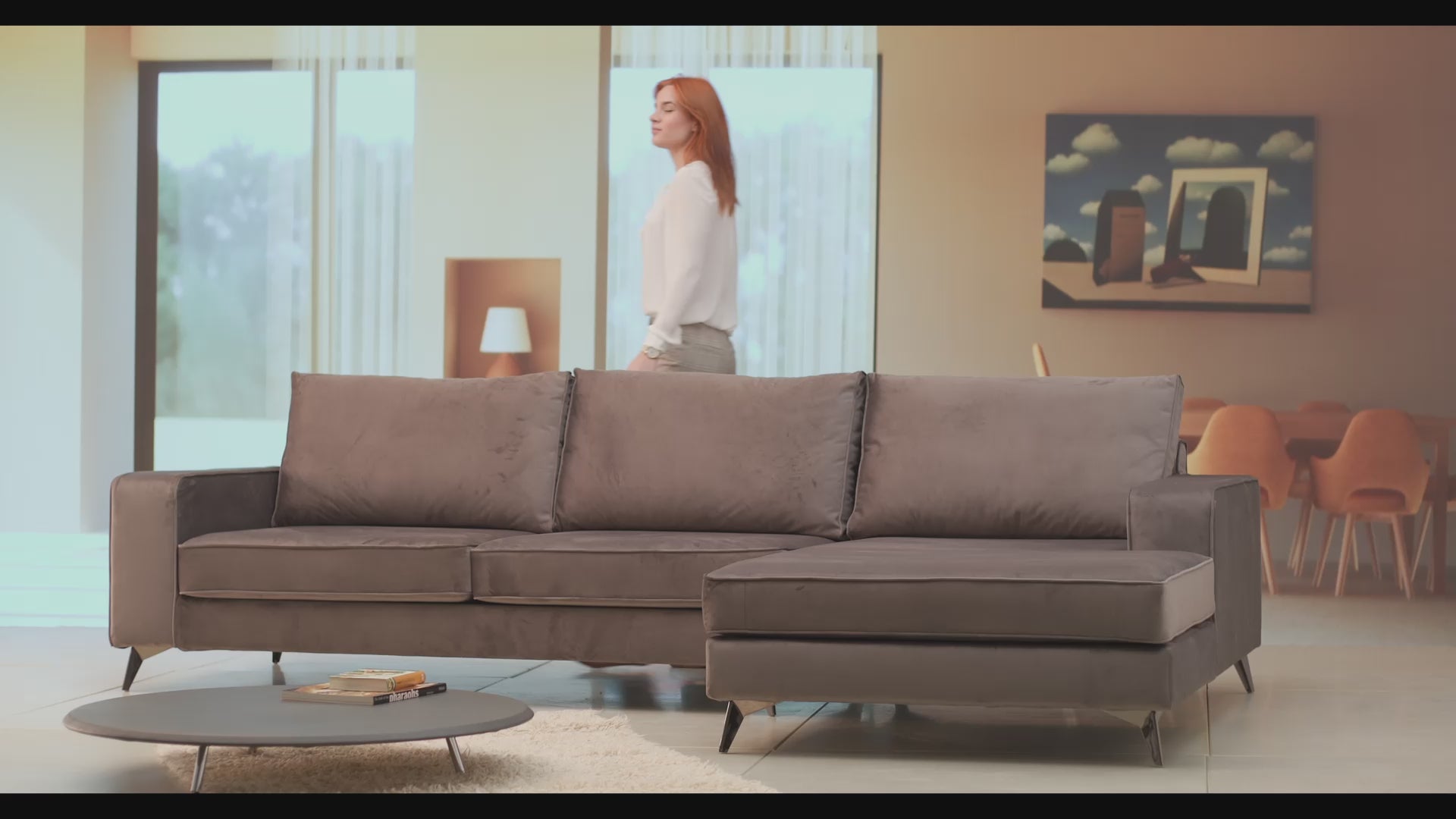 Video of the sofa Connor - brown color. Modern living room with women seating of the sofa.